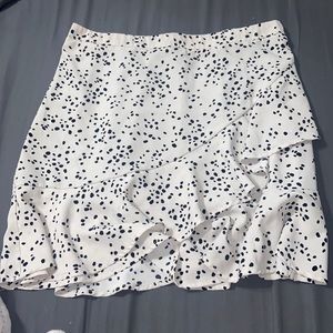 White skirt with black dots, one small faint stain at the top waist band